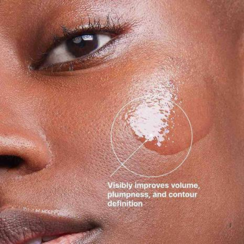 Close-up of a person's face with a cosmetic product applied, labeled for skincare benefits.