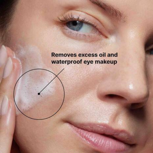 Close-up of a person applying a skincare product to their face with text indicating its use.